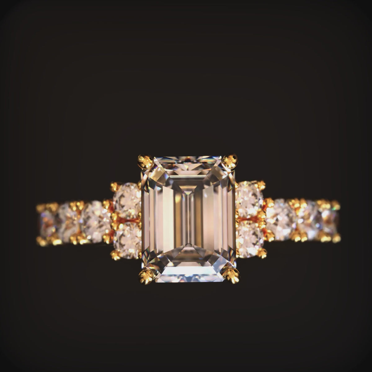 A solid gold ring with an emerald cut moissanite
