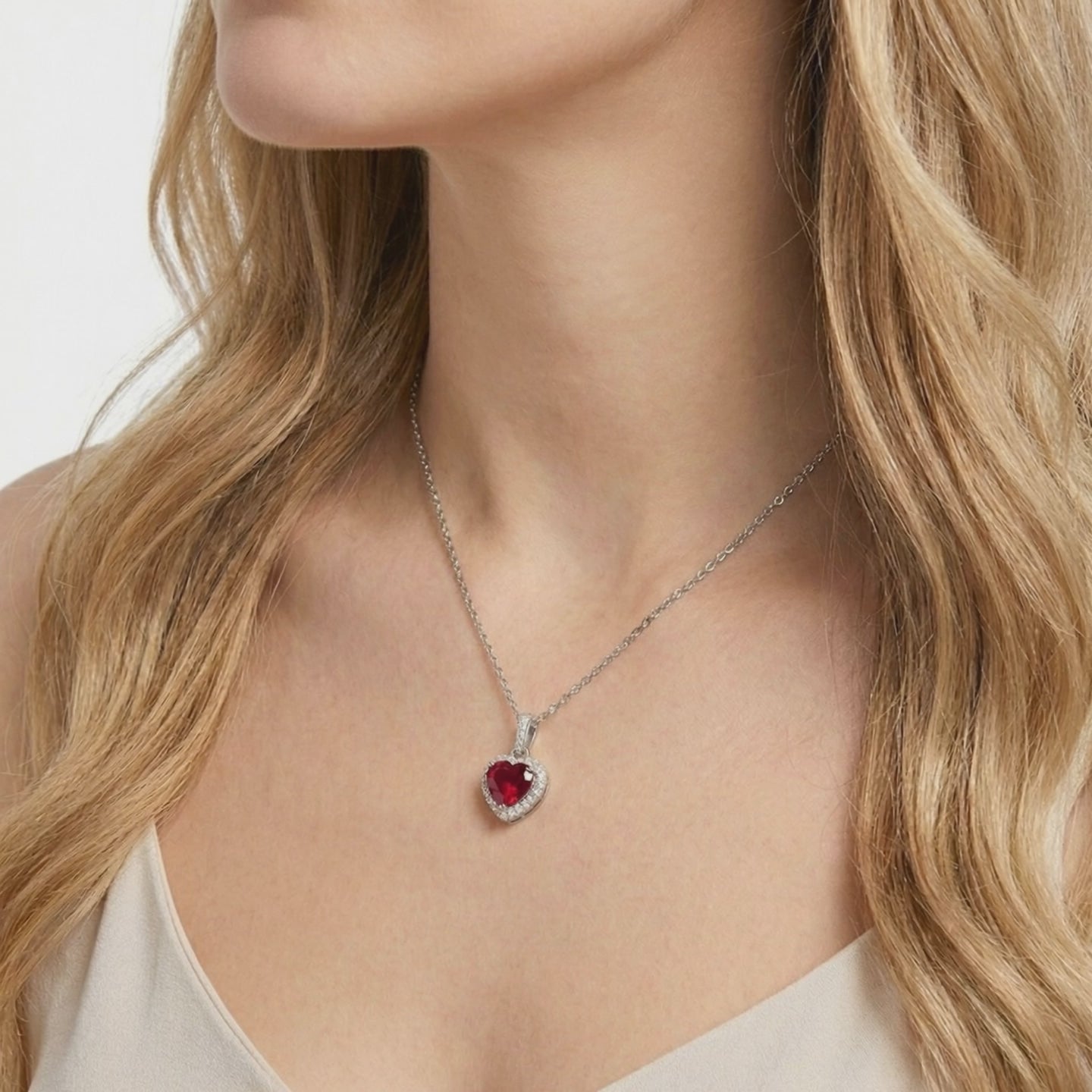 Heart-cut simulated ruby pendant necklace in solid gold.