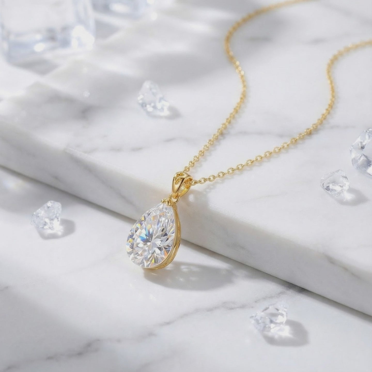 A solid gold necklace with a pear-cut A5 Zirconia pendant.