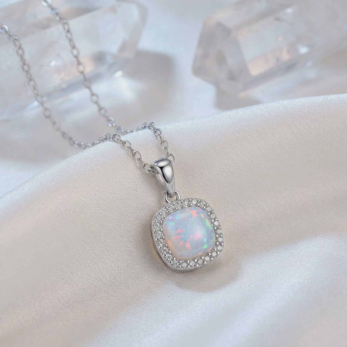 A solid gold cushion opal pendant necklace.