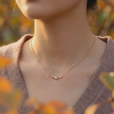 Solid gold necklace with a natural white opal column pendant.