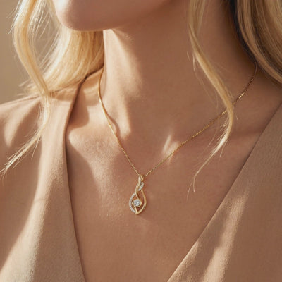 Model wearing the gold-tone Anneliese twisted pendant necklace with a round center stone.