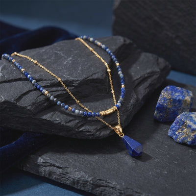 Solid gold necklace with natural lapis lazuli pendant and beads.
