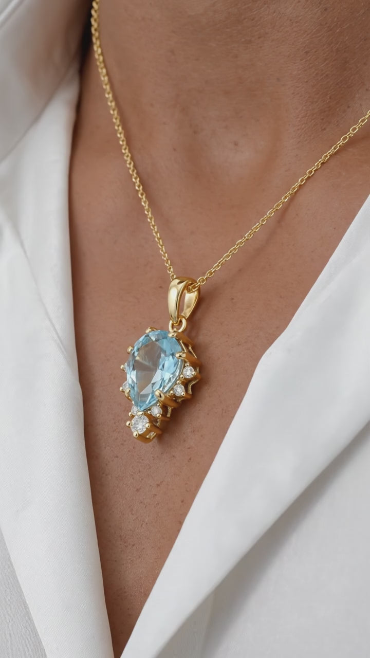 Simulated aquamarine solid gold necklace.