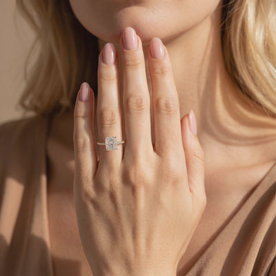 Video preview of a radiant-cut moissanite ring with a pavé band worn on a person's hand.