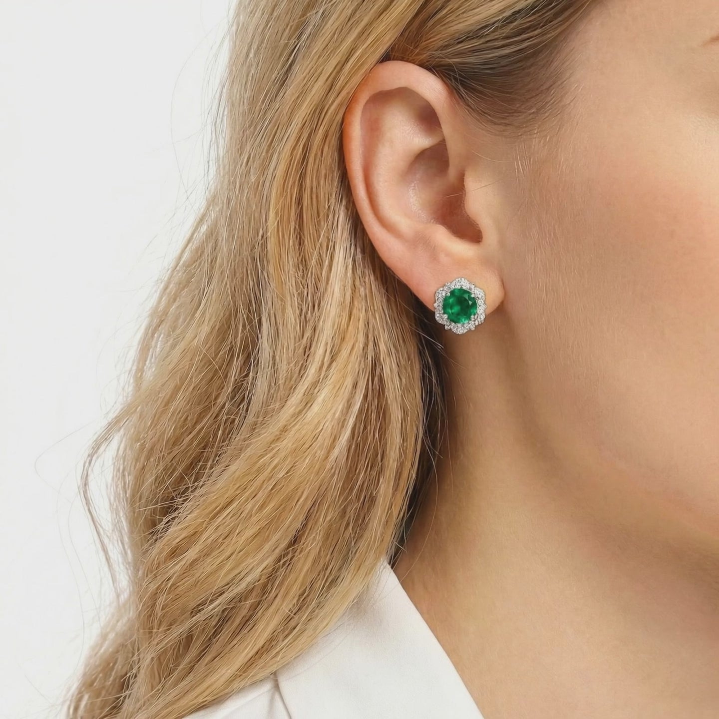 Solid gold stud earrings with simulated emeralds.