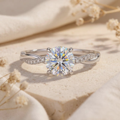 Close-up of the Sylviette silver ring showing its round center stone, four-prong setting, and twisted pavé band.