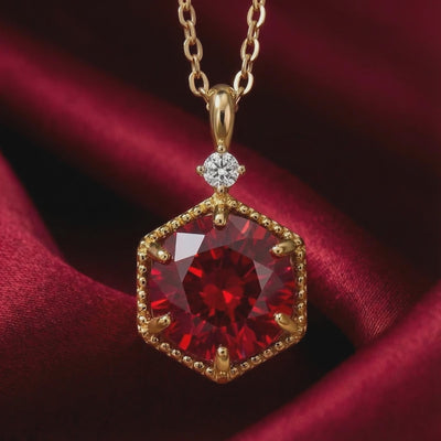 Solid gold necklace with hexagonal simulated ruby pendant.