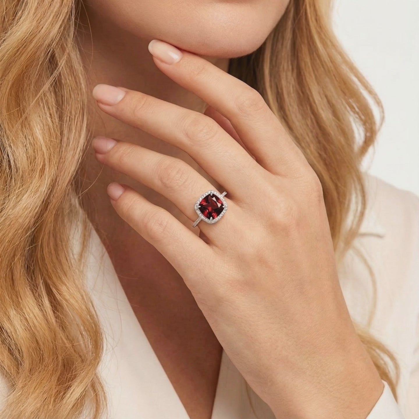 A solid gold ring with a simulated garnet stone.