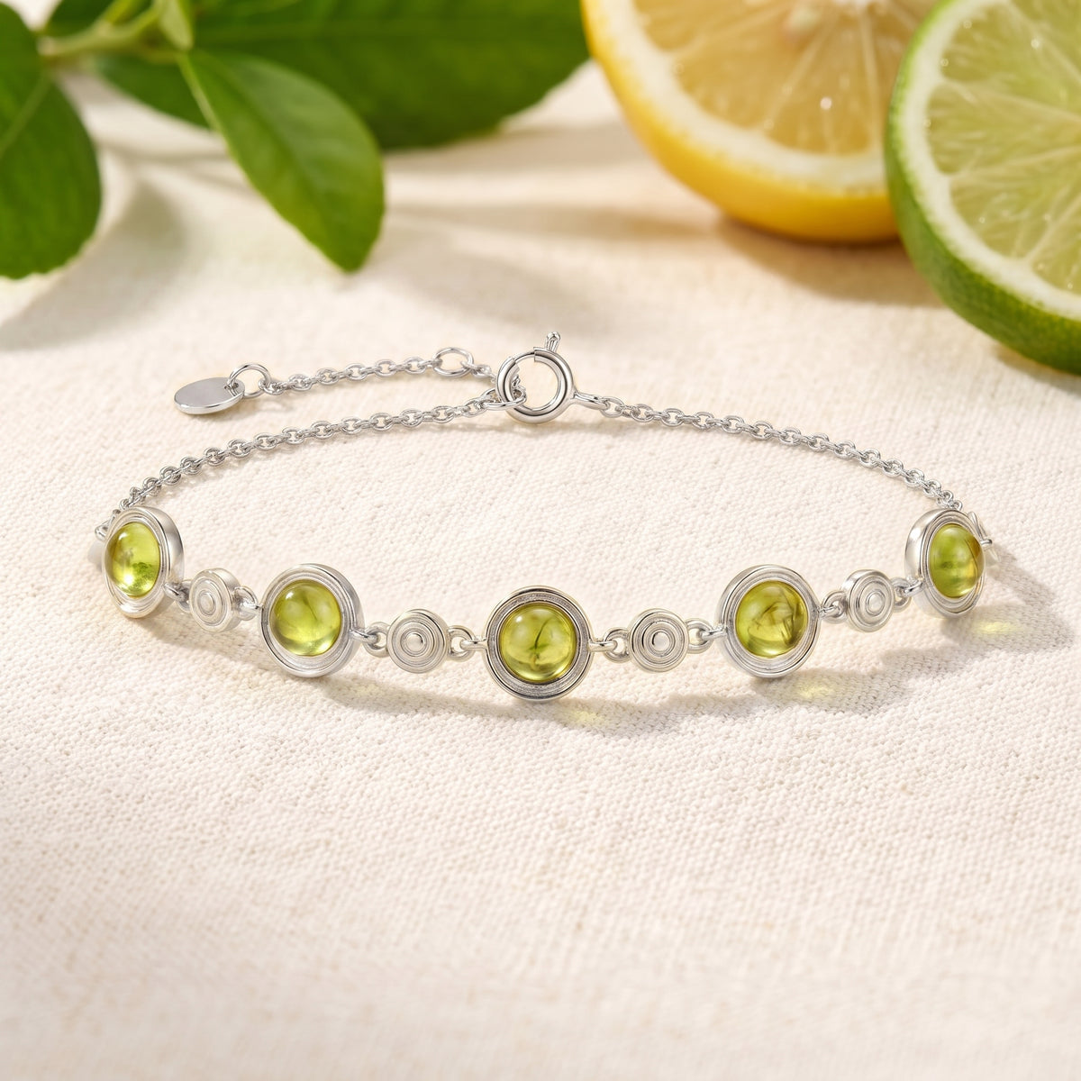 Solid white gold simulated peridot station bracelet.